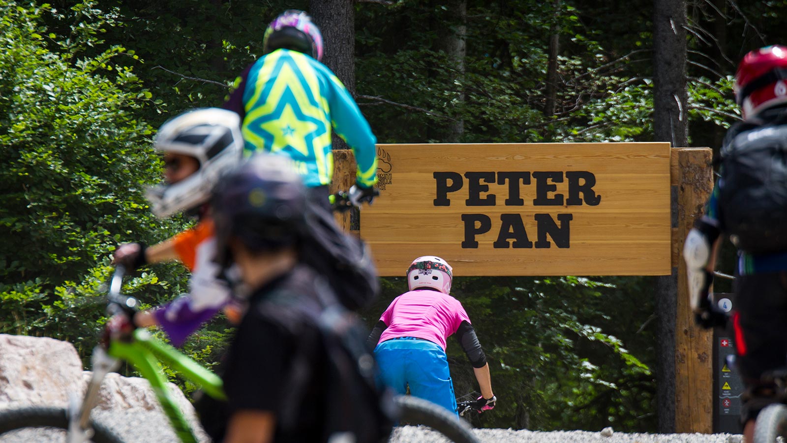 Detail of a sign that marks the path for children in a mountain bike holiday in Dolomites