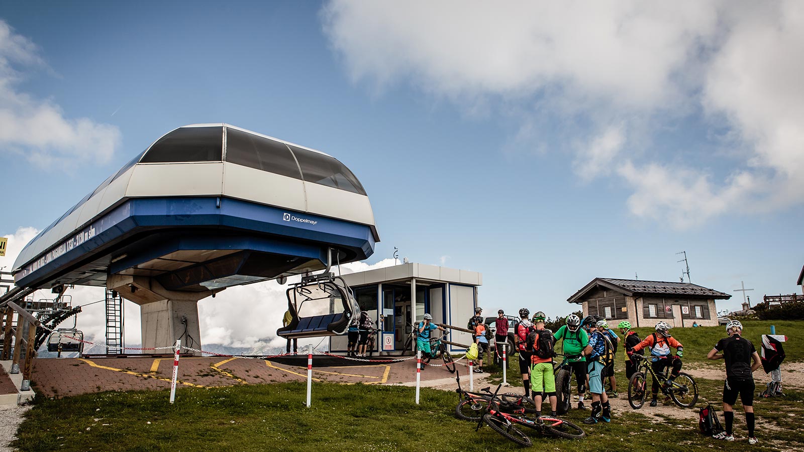 View of the chairlift and some cyclists in Andalo in Trentino
