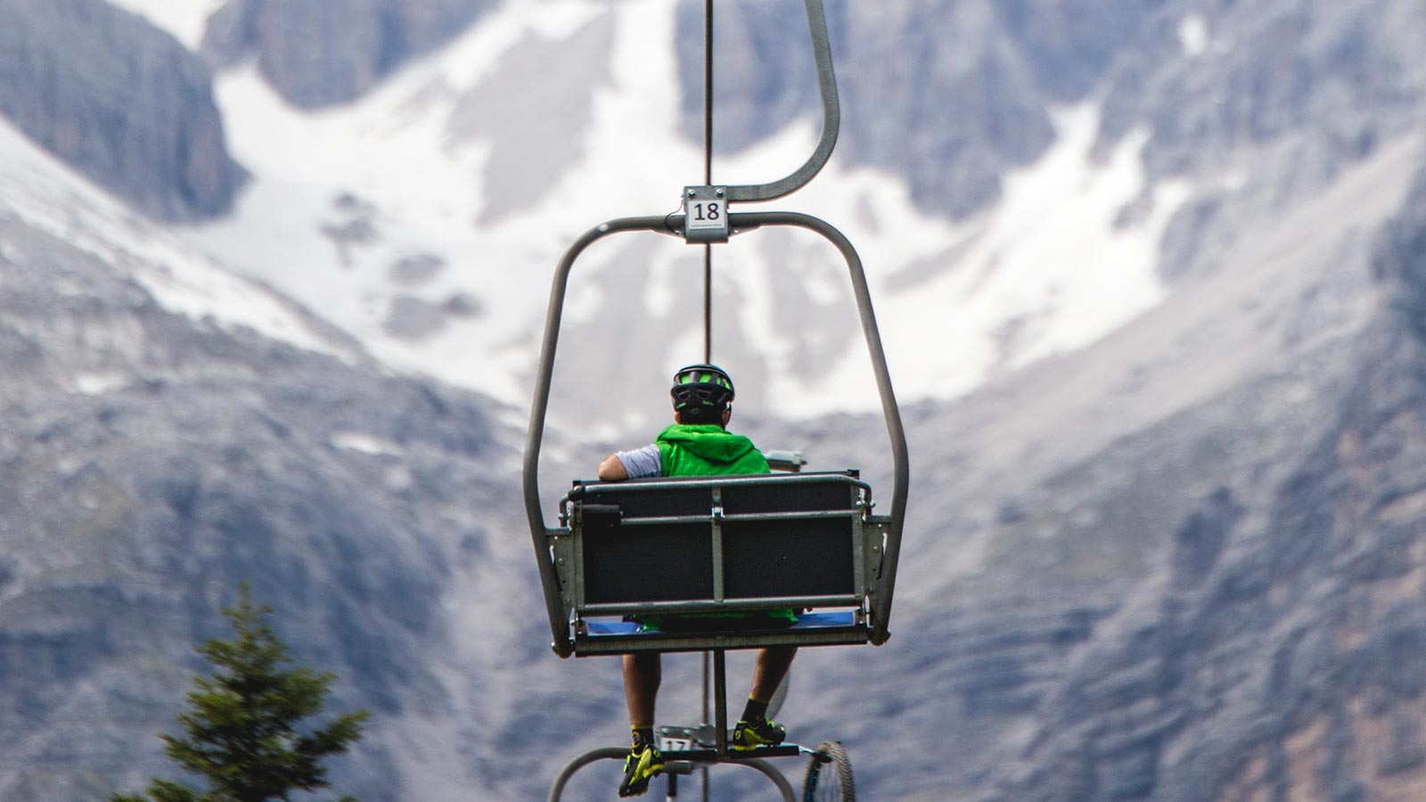 Detail of a cyclist on the chairlift around the Andalo ski resort